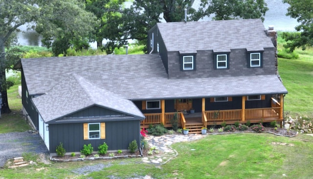 702 Polk Road 57, Mena, AR 71953 - view of front of property featuring board and batten siding, a front yard, and a shingled roof