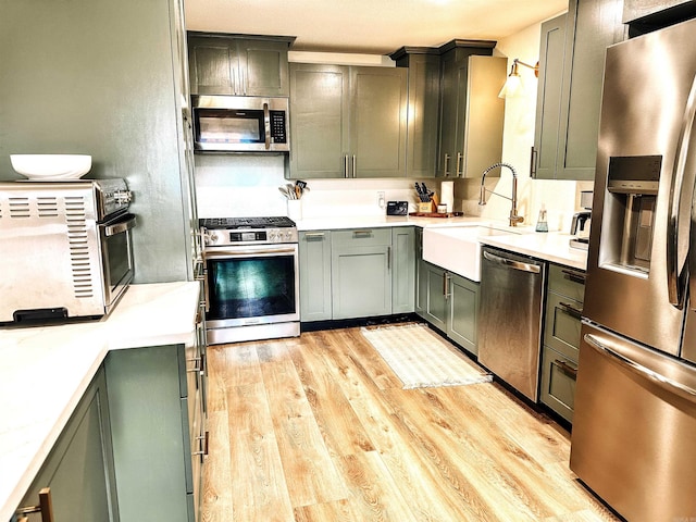 702 Polk Road 57, Mena, AR 71953 - kitchen with stainless steel appliances, light wood-style flooring, and light countertops
