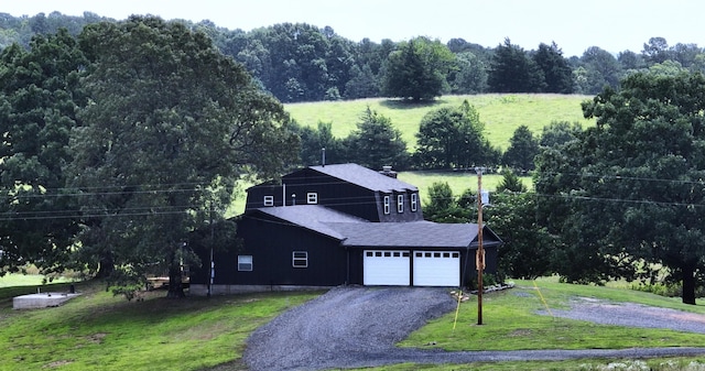 702 Polk Road 57, Mena, AR 71953 - view of front of property with an attached garage, a front lawn, driveway, and a shingled roof