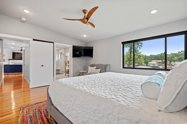 1113 Twin Points Rd, Hot Springs, AR 71913 - bedroom featuring light wood-style floors, vaulted ceiling, recessed lighting, a fireplace, and a ceiling fan