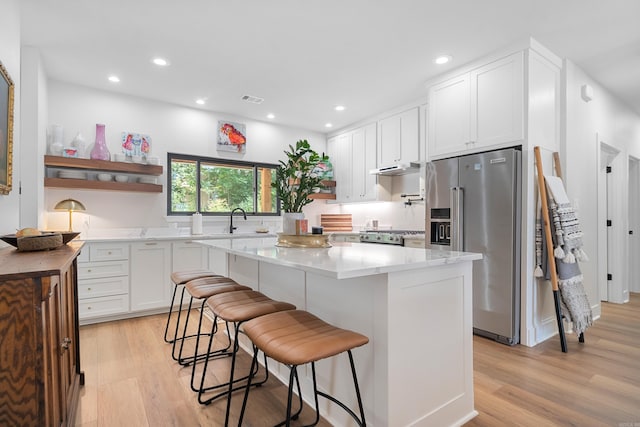 1113 Twin Points Rd, Hot Springs, AR 71913 - kitchen with high end fridge, light wood-style floors, white cabinets, and recessed lighting