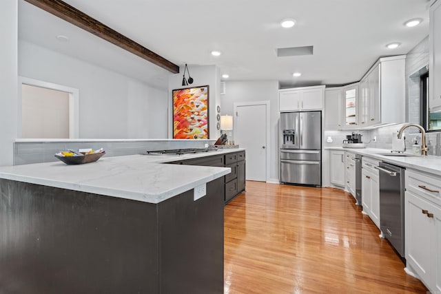 1113 Twin Points Rd, Hot Springs, AR 71913 - kitchen featuring stainless steel appliances, white cabinetry, light wood-style flooring, tasteful backsplash, and beamed ceiling