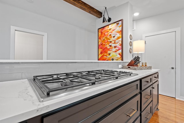 1113 Twin Points Rd, Hot Springs, AR 71913 - kitchen view of stainless steel gas cooktop, beam ceiling, light wood-style flooring, and light stone counters