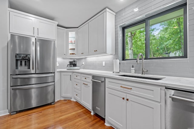 1113 Twin Points Rd, Hot Springs, AR 71913 - kitchen with appliances with stainless steel finishes, backsplash, white cabinetry, and light wood-type flooring