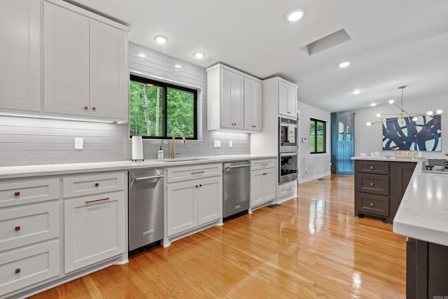 1113 Twin Points Rd, Hot Springs, AR 71913 - kitchen featuring appliances with stainless steel finishes, backsplash, light wood-type flooring, and recessed lighting