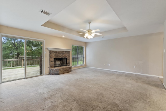53 E Main St, Greenbrier, AR 72058 - unfurnished living room featuring a tray ceiling, plenty of natural light, and carpet flooring