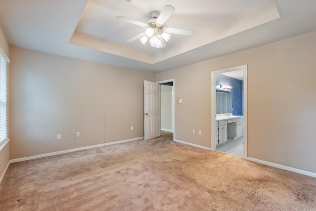 53 E Main St, Greenbrier, AR 72058 - unfurnished bedroom featuring a tray ceiling, carpet, connected bathroom, and multiple windows