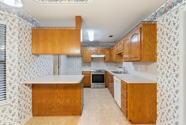 53 E Main St, Greenbrier, AR 72058 - kitchen with wallpapered walls, electric range, a peninsula, light countertops, and brown cabinets