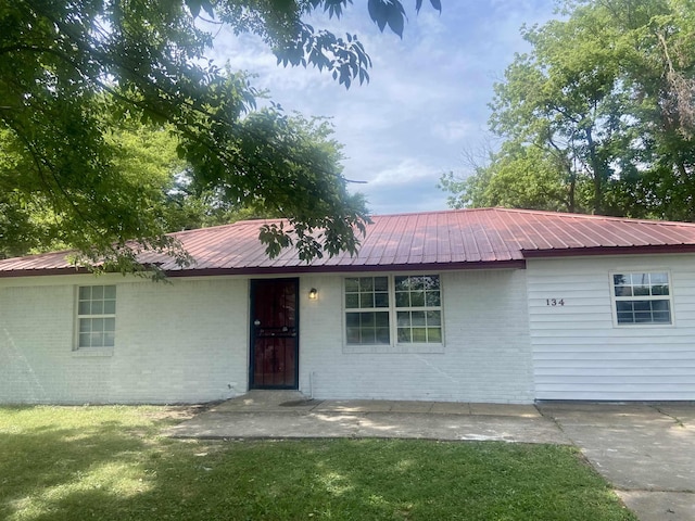 134 S Gosnell St, Gosnell, AR 72315 - ranch-style house featuring brick siding and a metal roof