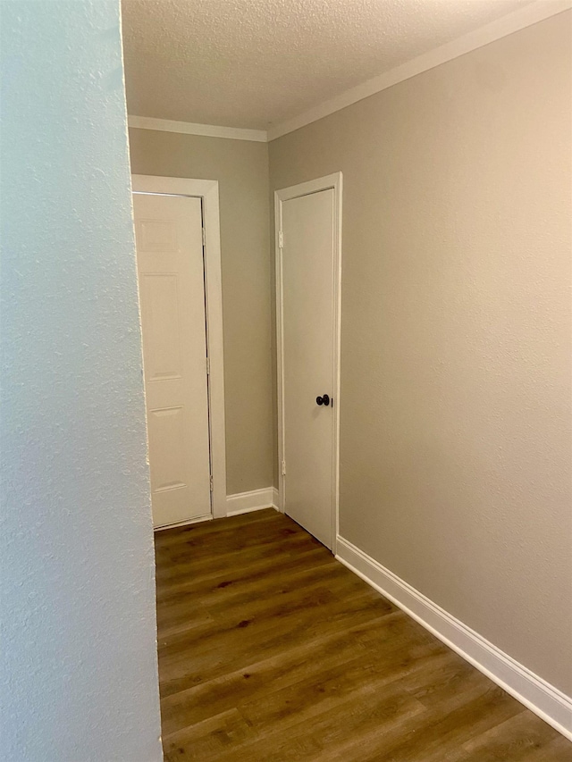134 S Gosnell St, Gosnell, AR 72315 - hall featuring ornamental molding, dark wood finished floors, and a textured ceiling