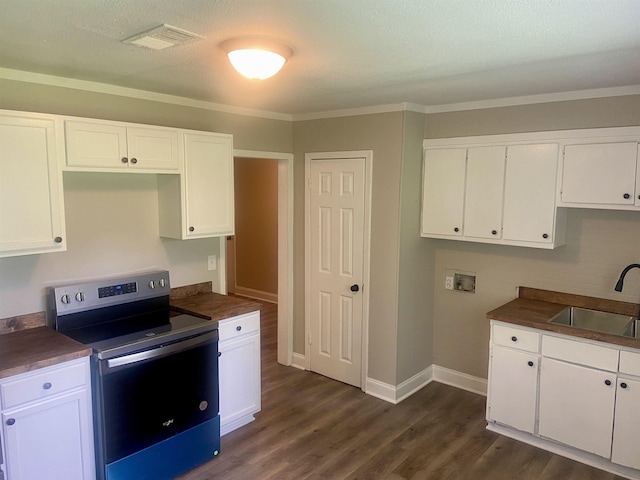 134 S Gosnell St, Gosnell, AR 72315 - kitchen featuring stainless steel electric range, dark countertops, dark wood finished floors, and ornamental molding