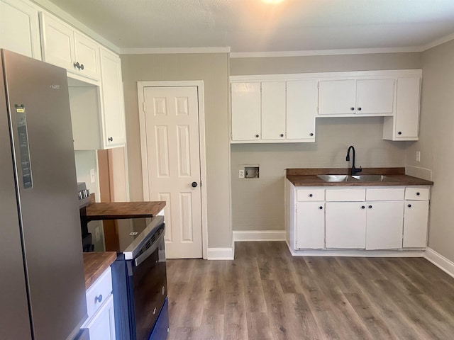 134 S Gosnell St, Gosnell, AR 72315 - kitchen featuring freestanding refrigerator, electric stove, dark countertops, dark wood-type flooring, and white cabinets