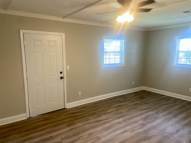 134 S Gosnell St, Gosnell, AR 72315 - spare room featuring dark wood finished floors and a ceiling fan