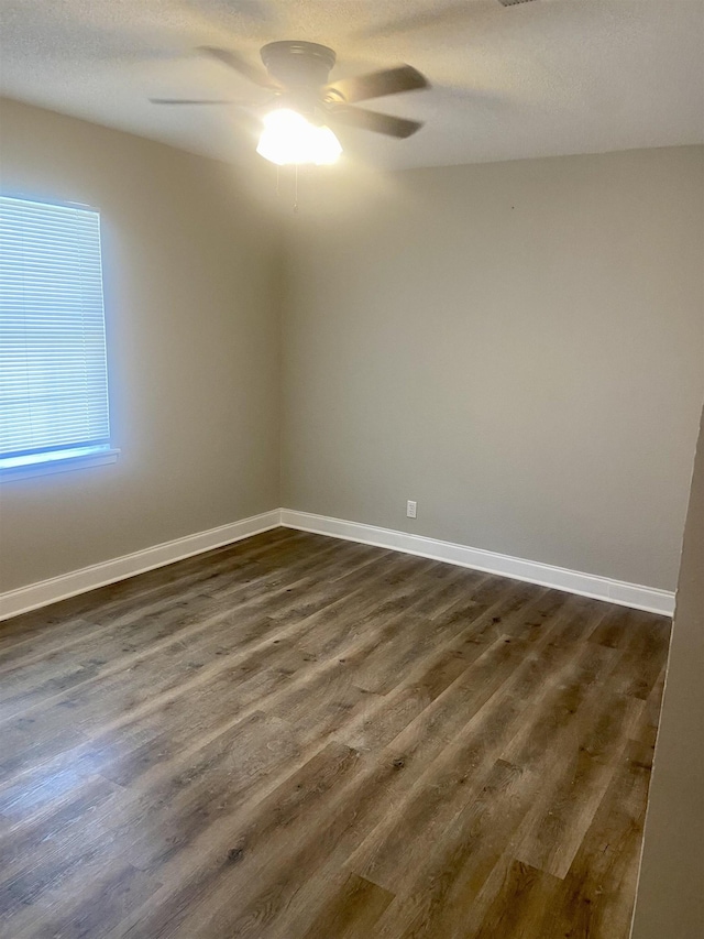 134 S Gosnell St, Gosnell, AR 72315 - spare room with a ceiling fan and dark wood-style flooring