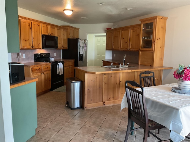 497 Ben Rd, Drasco, AR 72530 - kitchen featuring black appliances, a peninsula, glass insert cabinets, light tile patterned flooring, and light countertops