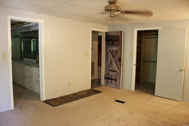 196 Stone Mountain Rd, Vilonia, AR 72032 - unfurnished bedroom featuring carpet floors, ensuite bathroom, and a textured ceiling