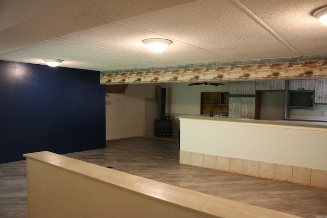 196 Stone Mountain Rd, Vilonia, AR 72032 - bar area with a wood stove, dark wood-type flooring, and ceiling fan