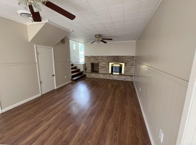 17Hagan Drive, Pine Bluff, AR 71603 - unfurnished living room featuring a ceiling fan, dark wood-style floors, a glass covered fireplace, stairs, and ornamental molding