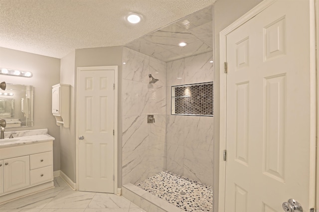 1900 Andy Cv, White Hall, AR 71602 - bathroom with vanity, marble finish flooring, a marble finish shower, and a textured ceiling