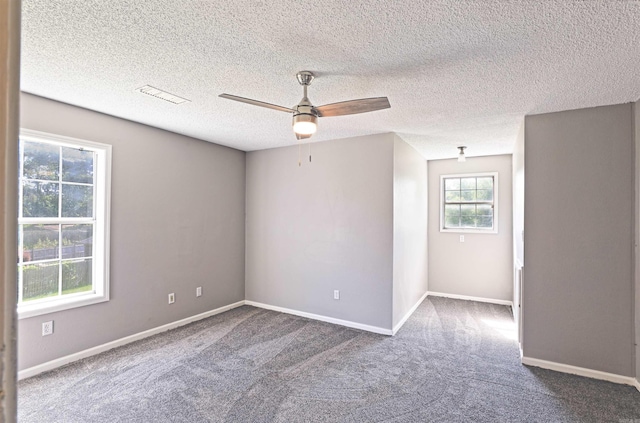 1900 Andy Cv, White Hall, AR 71602 - empty room with dark carpet, ceiling fan, and a textured ceiling