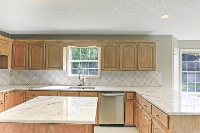1900 Andy Cv, White Hall, AR 71602 - kitchen with stainless steel dishwasher, a peninsula, light stone counters, backsplash, and a textured ceiling