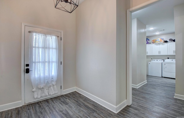 226 Shamsie Ln, White Hall, AR 71602 - foyer entrance featuring washing machine and clothes dryer, dark wood-type flooring, and a chandelier
