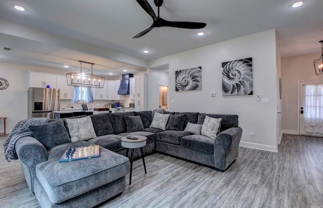 226 Shamsie Ln, White Hall, AR 71602 - living area featuring ceiling fan, light wood-type flooring, recessed lighting, plenty of natural light, and a chandelier
