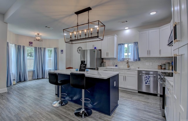226 Shamsie Ln, White Hall, AR 71602 - kitchen with stainless steel appliances, plenty of natural light, a kitchen island, decorative backsplash, and recessed lighting