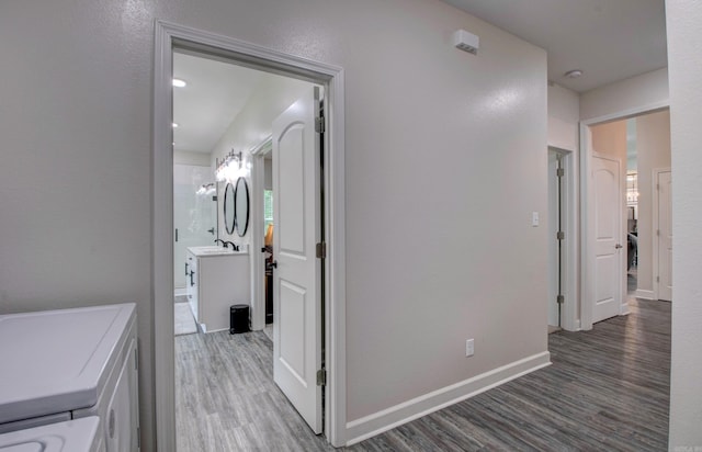 226 Shamsie Ln, White Hall, AR 71602 - hallway featuring washing machine and dryer and wood finished floors