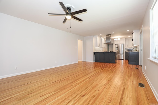 1913 Topf Rd, North Little Rock, AR 72116 - unfurnished living room with ceiling fan, light wood finished floors, and recessed lighting