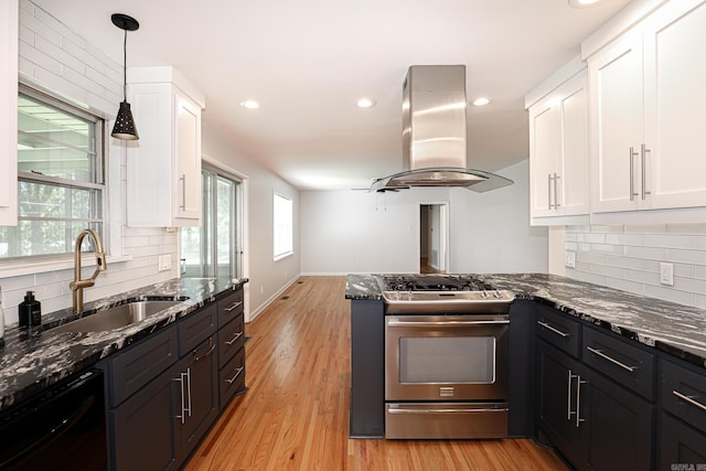 1913 Topf Rd, North Little Rock, AR 72116 - kitchen featuring stainless steel range with gas stovetop, island range hood, dishwasher, white cabinetry, and backsplash