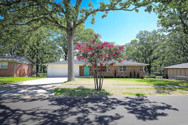 1913 Topf Rd, North Little Rock, AR 72116 - view of front of property featuring driveway, a front yard, brick siding, and an attached garage