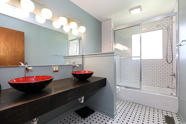 1913 Topf Rd, North Little Rock, AR 72116 - bathroom featuring bath / shower combo with glass door and double vanity