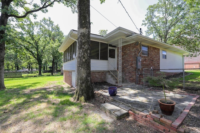 1913 Topf Rd, North Little Rock, AR 72116 - rear view of house featuring a sunroom, a patio area, entry steps, and brick siding