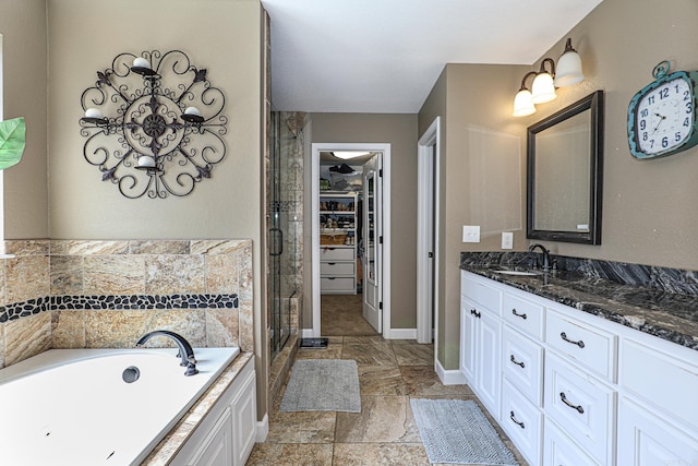506 Scarlet Oaks Cv, Benton, AR 72019 - bathroom with vanity, a shower stall, a garden tub, and a walk in closet