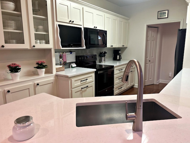 3 Timber Ridge Cir, Arkadelphia, AR 71923 - kitchen featuring black appliances, backsplash, glass insert cabinets, and white cabinetry
