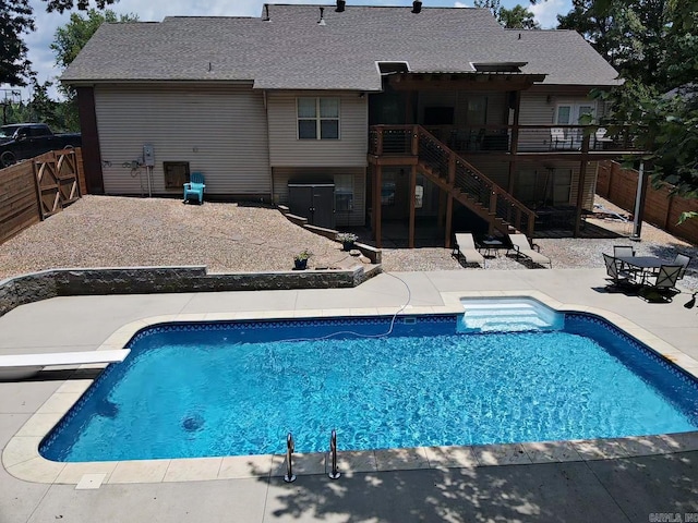 3 Timber Ridge Cir, Arkadelphia, AR 71923 - outdoor pool featuring stairs, a wooden deck, a fenced backyard, a patio area, and a diving board