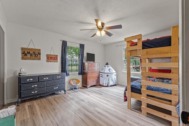 508 Cindy St, Paragould, AR 72450 - bedroom featuring light wood-style floors, a textured ceiling, and a ceiling fan