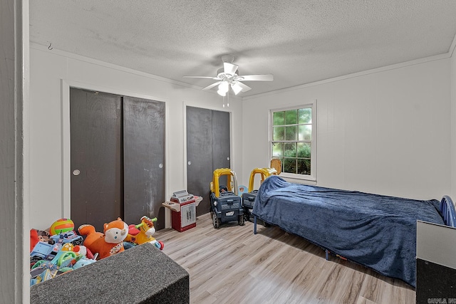 508 Cindy St, Paragould, AR 72450 - bedroom featuring wood finished floors, multiple closets, ceiling fan, and a textured ceiling