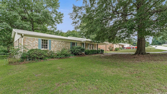 508 Cindy St, Paragould, AR 72450 - ranch-style home featuring brick siding, a front lawn, and a metal roof
