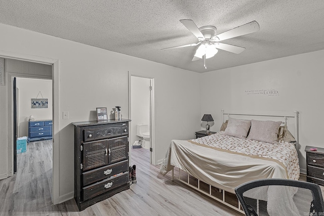 508 Cindy St, Paragould, AR 72450 - bedroom featuring light wood-style floors, a textured ceiling, ensuite bath, and a ceiling fan