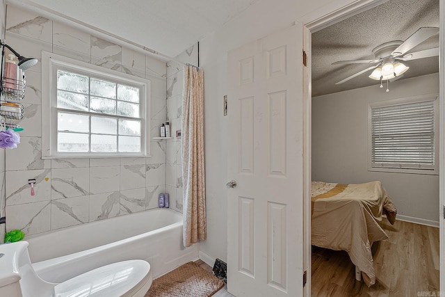 508 Cindy St, Paragould, AR 72450 - bathroom featuring shower / bath combination with curtain, wood finished floors, a ceiling fan, and a textured ceiling