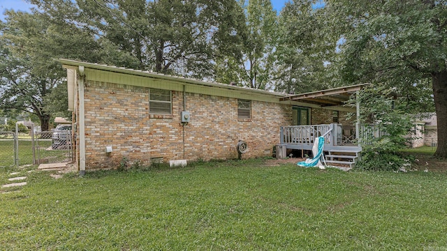 508 Cindy St, Paragould, AR 72450 - back of house featuring a deck, a gate, and brick siding