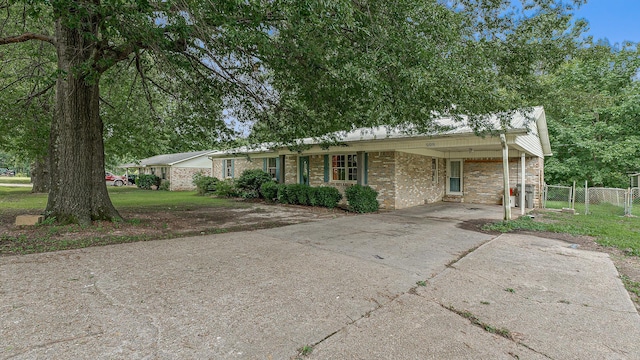 508 Cindy St, Paragould, AR 72450 - ranch-style house with concrete driveway, brick siding, and an attached carport