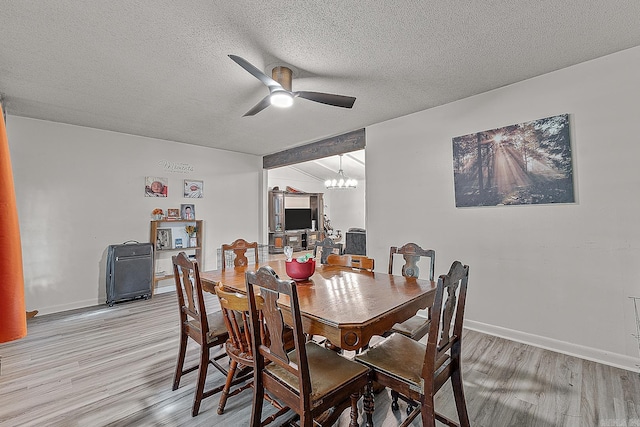 508 Cindy St, Paragould, AR 72450 - dining room with light wood finished floors, a ceiling fan, a textured ceiling, and a chandelier