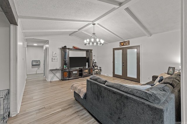 508 Cindy St, Paragould, AR 72450 - living room featuring french doors, a textured ceiling, light wood-type flooring, and a chandelier