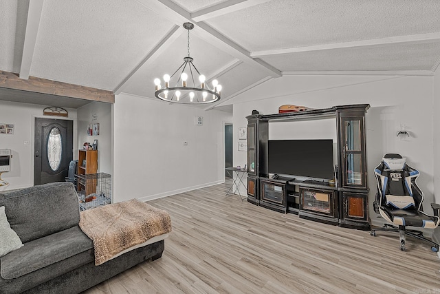 508 Cindy St, Paragould, AR 72450 - living room featuring wood finished floors, a chandelier, and a textured ceiling
