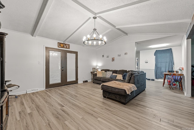508 Cindy St, Paragould, AR 72450 - living room featuring french doors, light wood-style flooring, a chandelier, and a textured ceiling