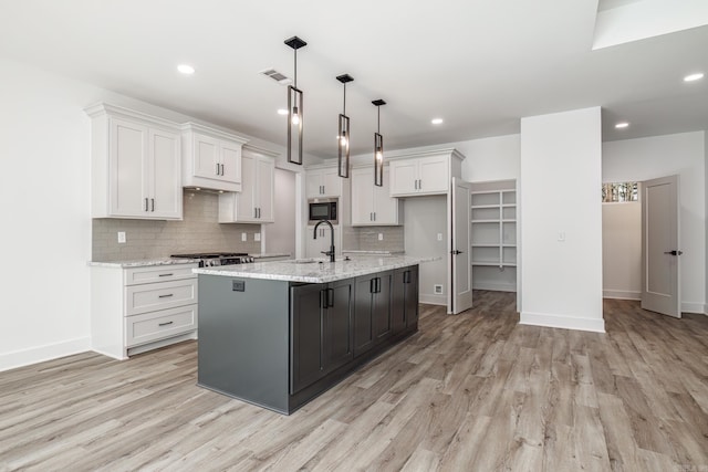 60 Estrella Way, Hot Springs Village, AR 71909 - kitchen with appliances with stainless steel finishes, white cabinets, light wood finished floors, decorative backsplash, and recessed lighting
