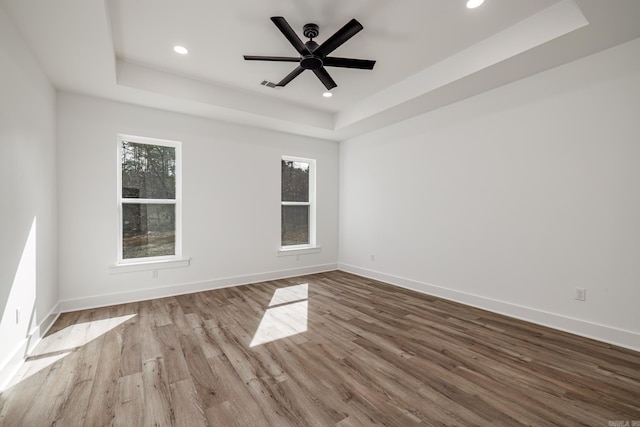 60 Estrella Way, Hot Springs Village, AR 71909 - unfurnished room featuring a tray ceiling, wood finished floors, recessed lighting, and a ceiling fan